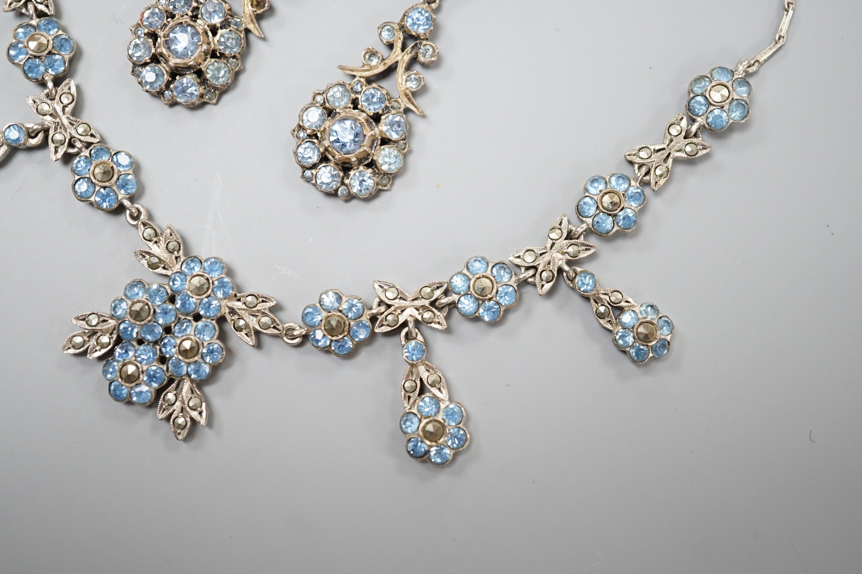 A base metal, marcasite and blue paste set necklace and pair of matching drop earrings, necklace 41cm, earrings 42mm.